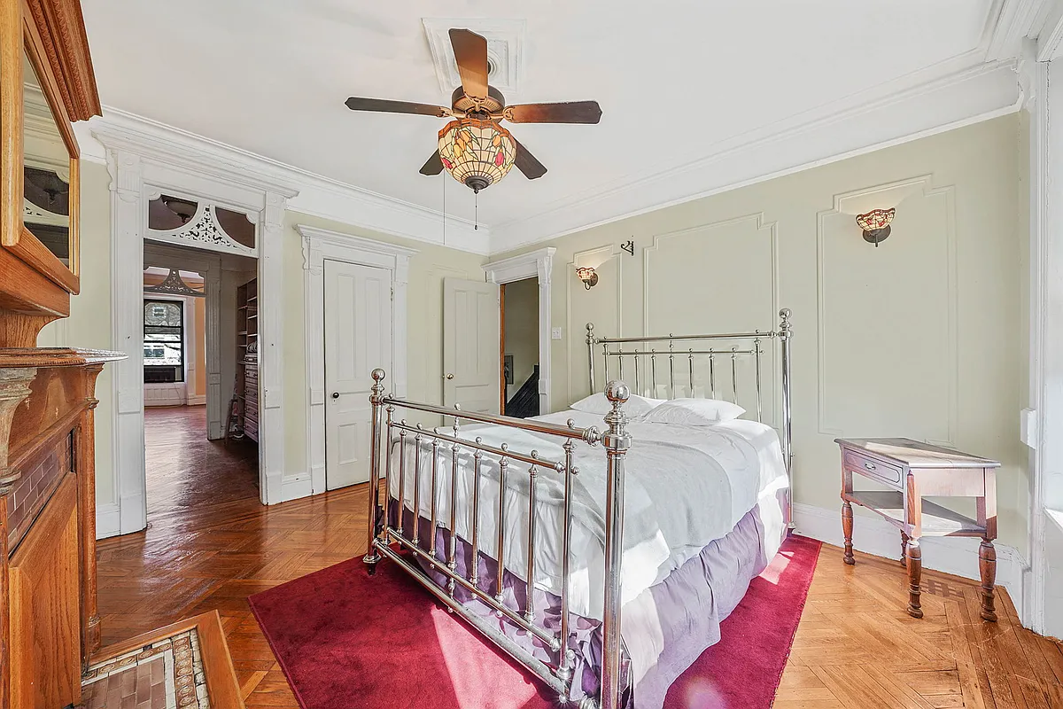 bedroom with fretwork, wall moldings,