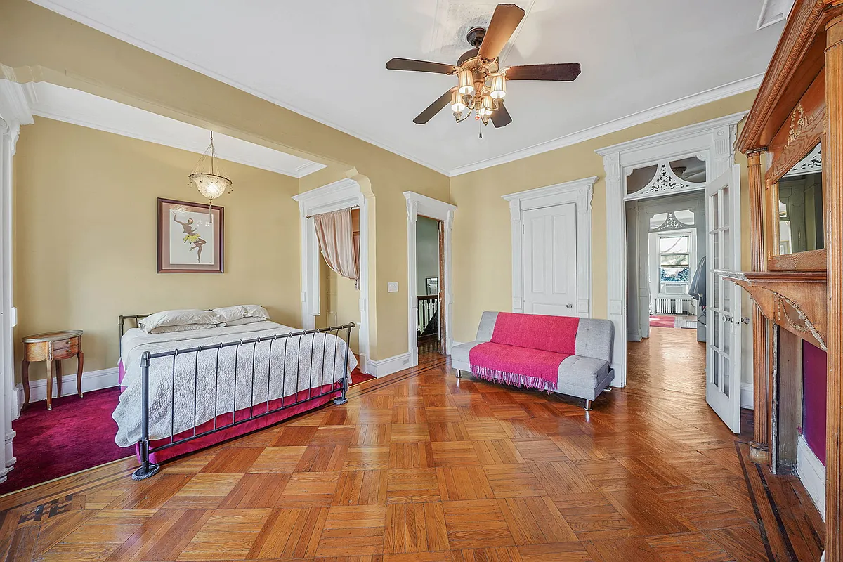 bedroom with bed niche, mantel