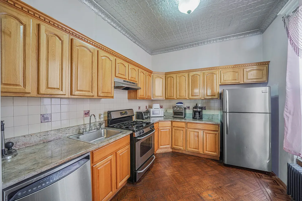 kitchen with wood cabinets, tin ceiling