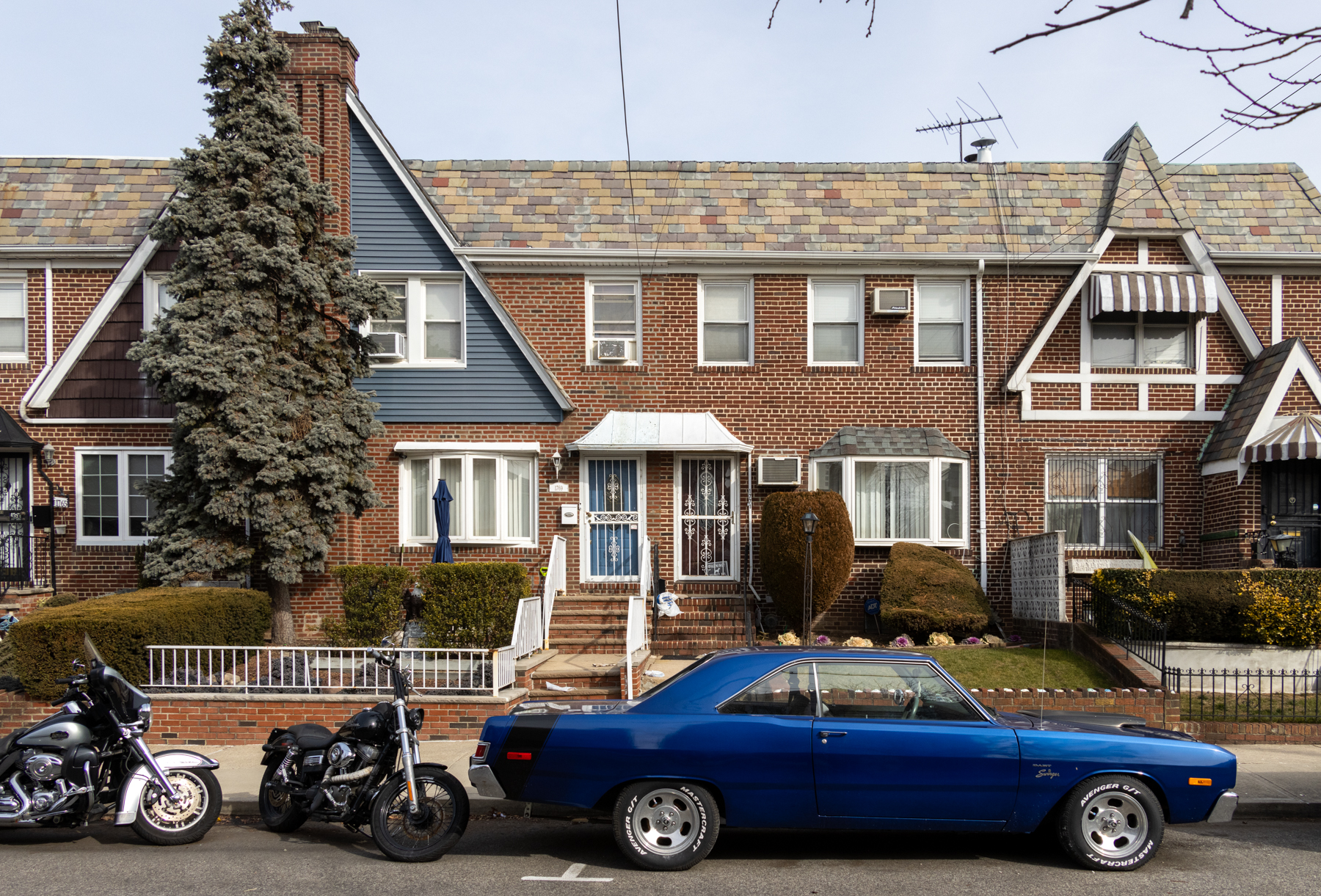 brooklyn - vintage blue car parked in front of tudor row houses in marine park