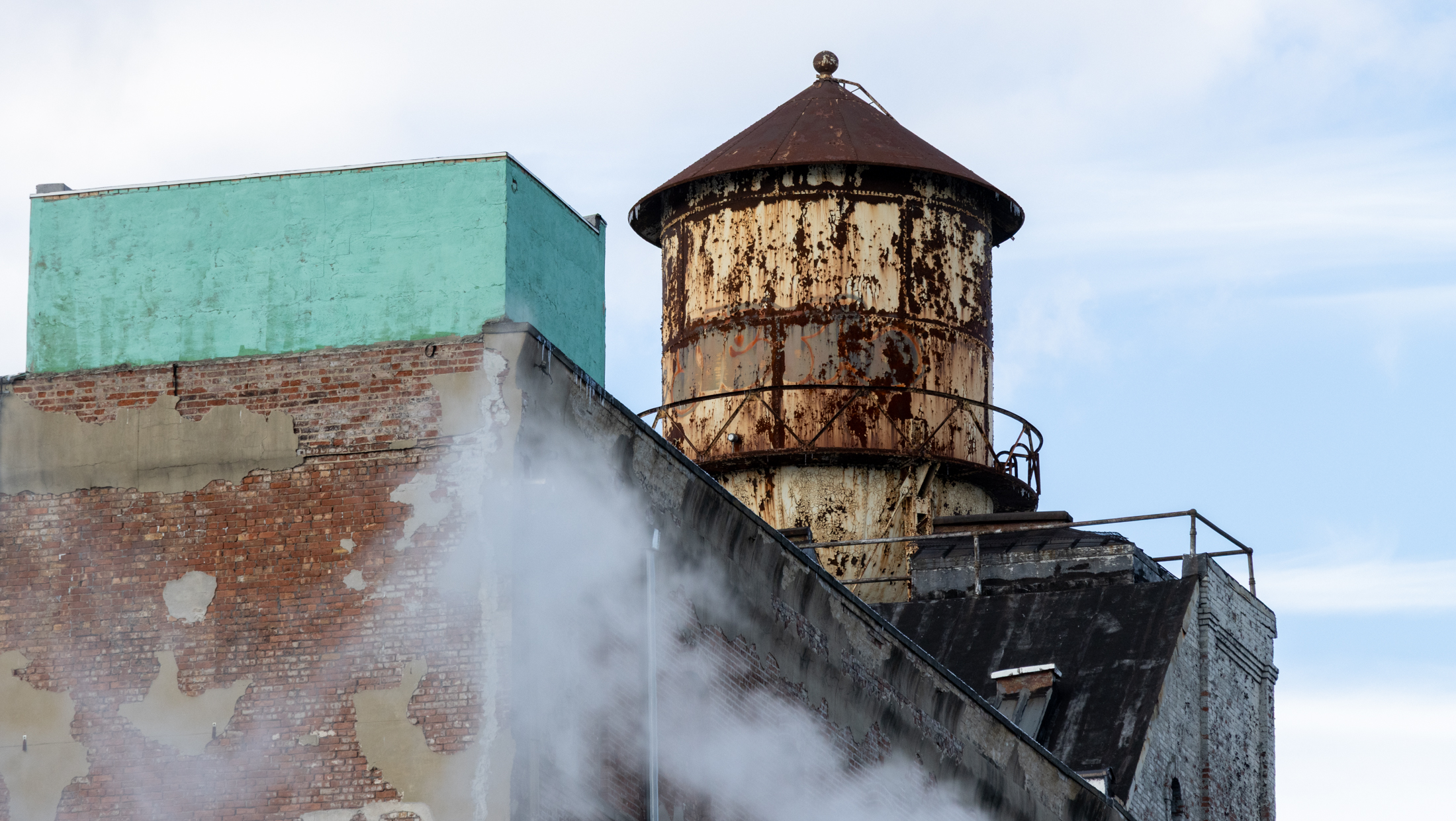 brooklyn - watertower with steam rising in front of it in clinton hill