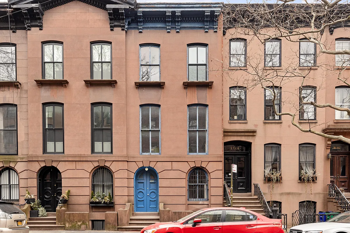 cobble hill - brownstone front facade with a blue door and cornice