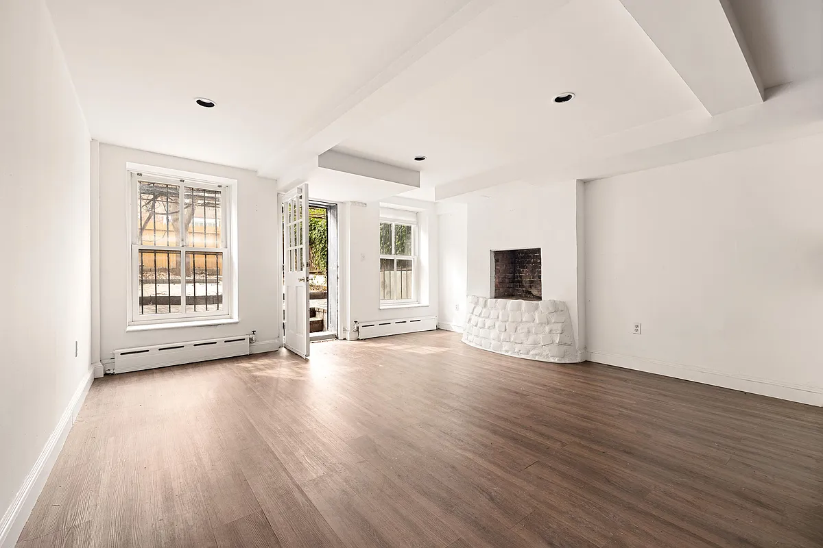 garden level living room with fireplace, door to the garden