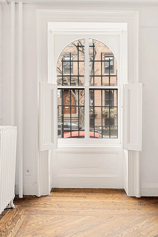 arched window with interior shutters