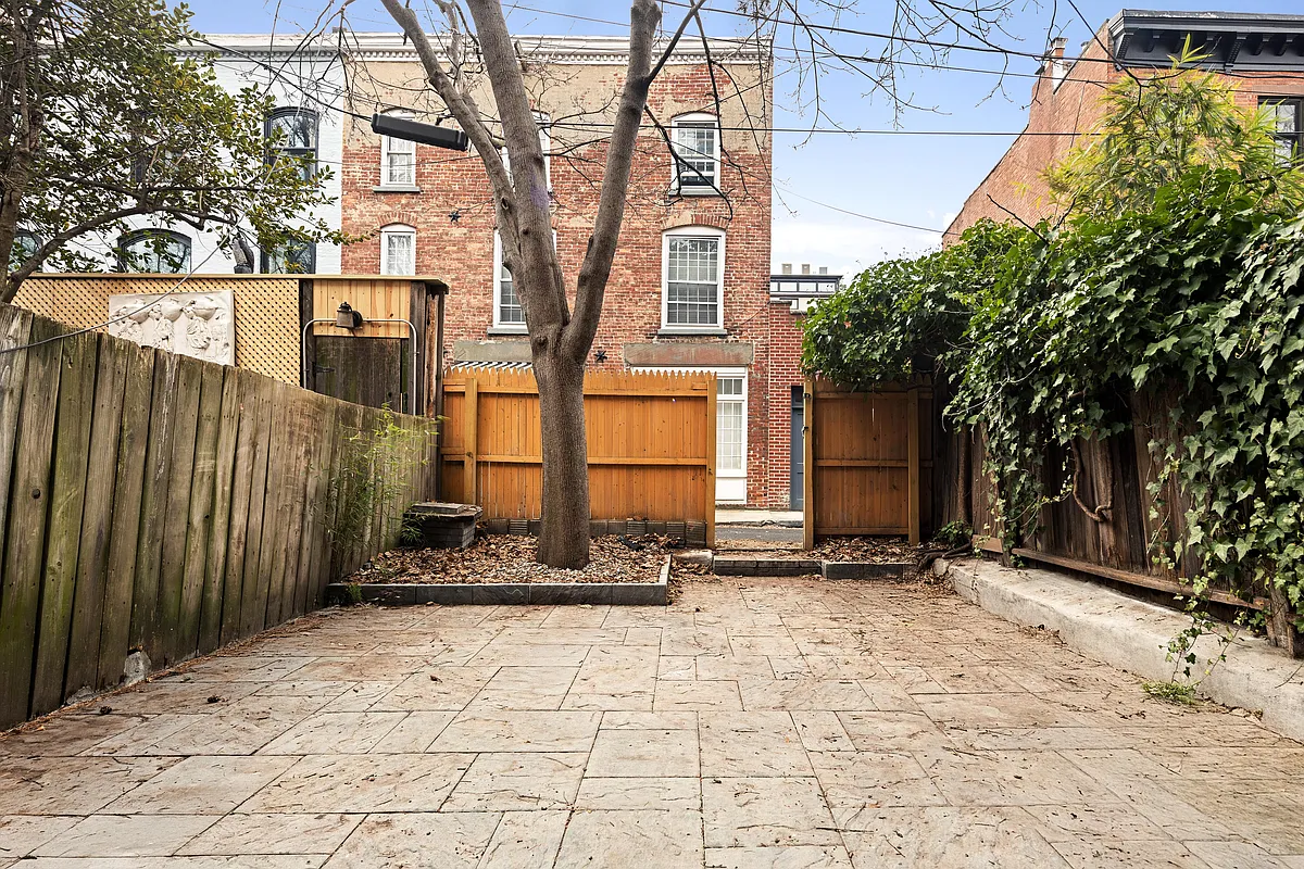 paved rear yard with a gate out onto Verandah Place