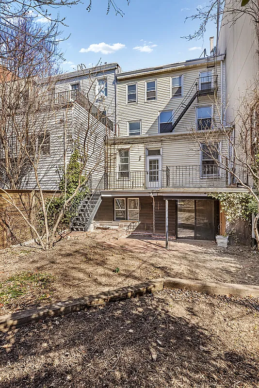 view of rear yard and wood frame rear facade