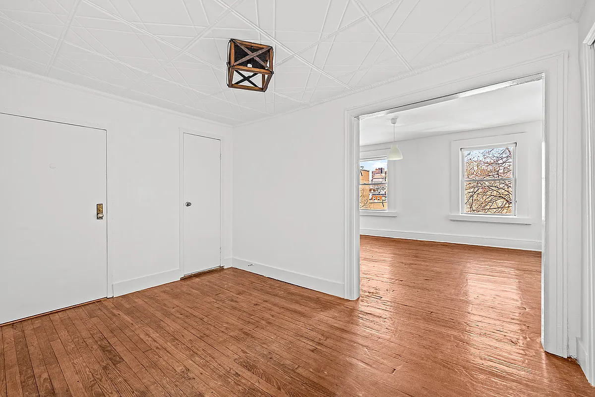 upper unit rooms with wood floors, white walls