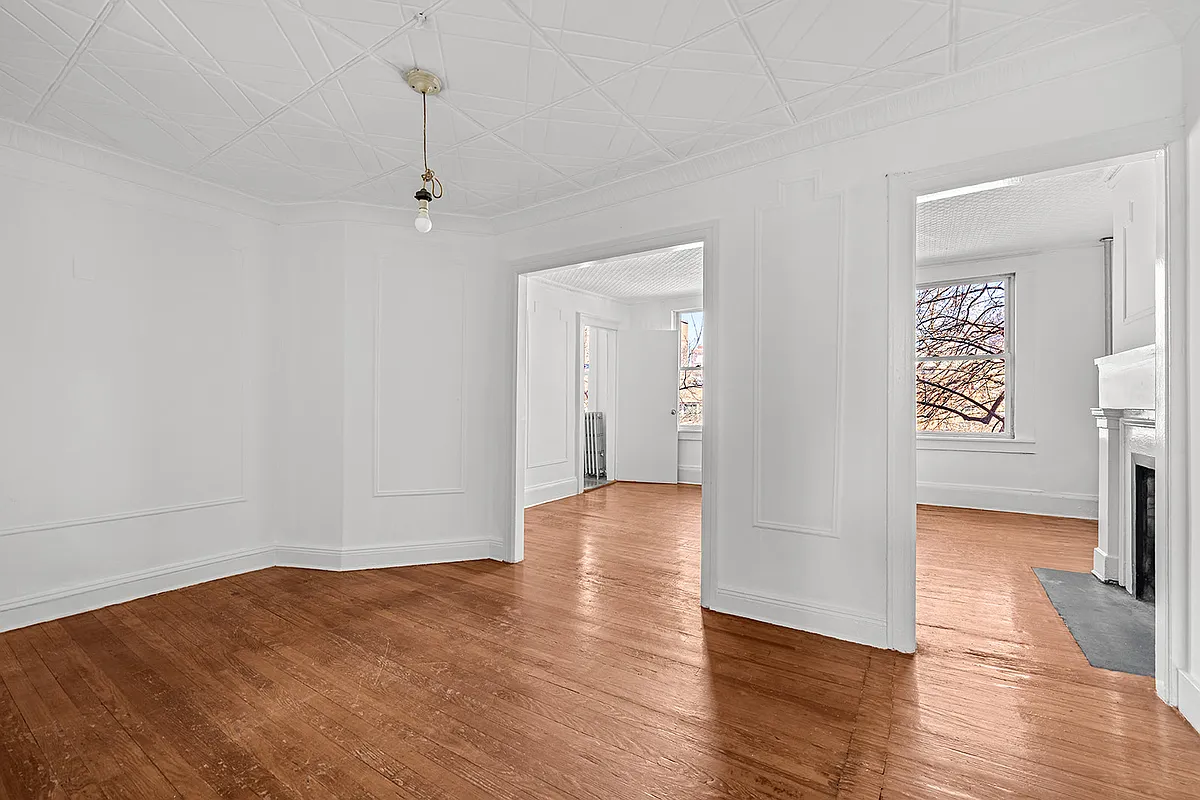 upstairs unit with a wall moldings, greek revival mantel