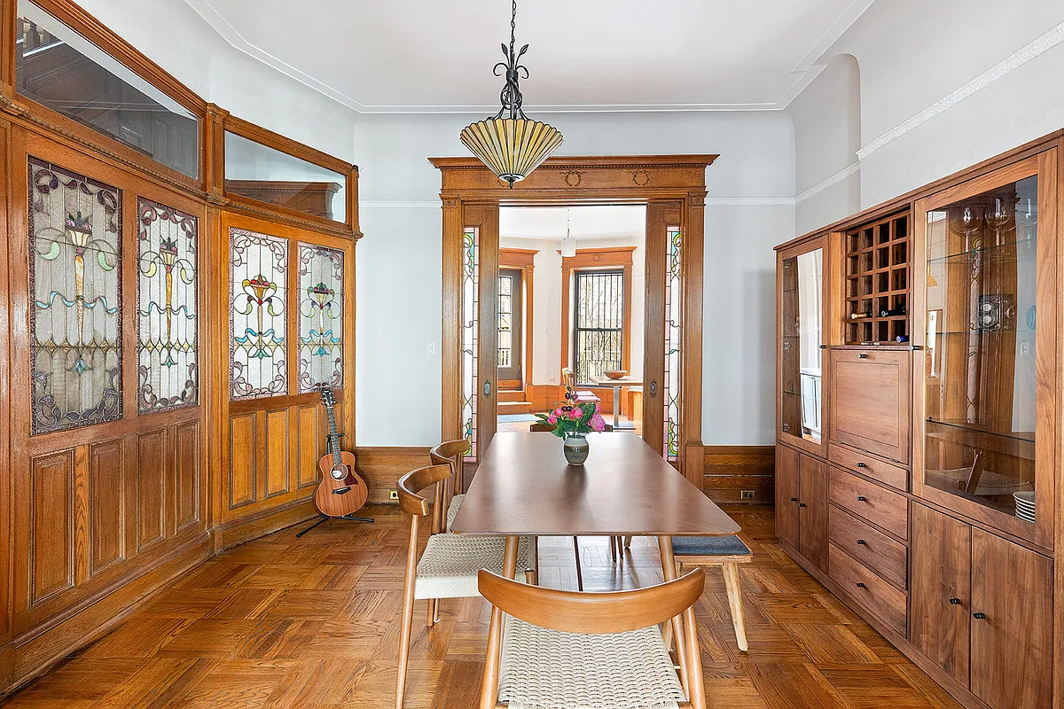 dining room with wood floor, stained glass pocket doors