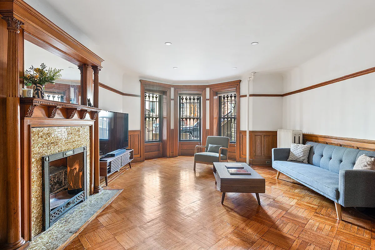 garden level dining room with wainscoting, mantel set up as a living room
