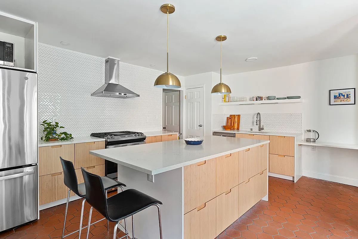 kitchen with terra cotta tile floor, white tile backsplash