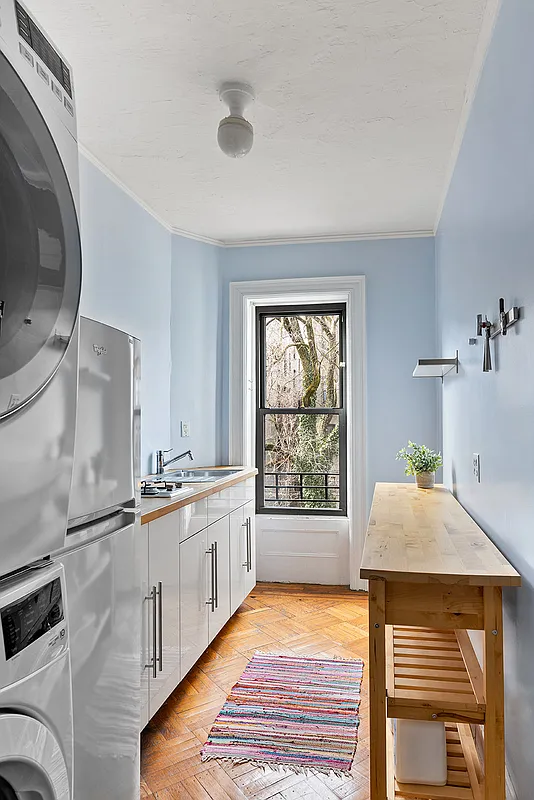 laundry room with sink, stackable units