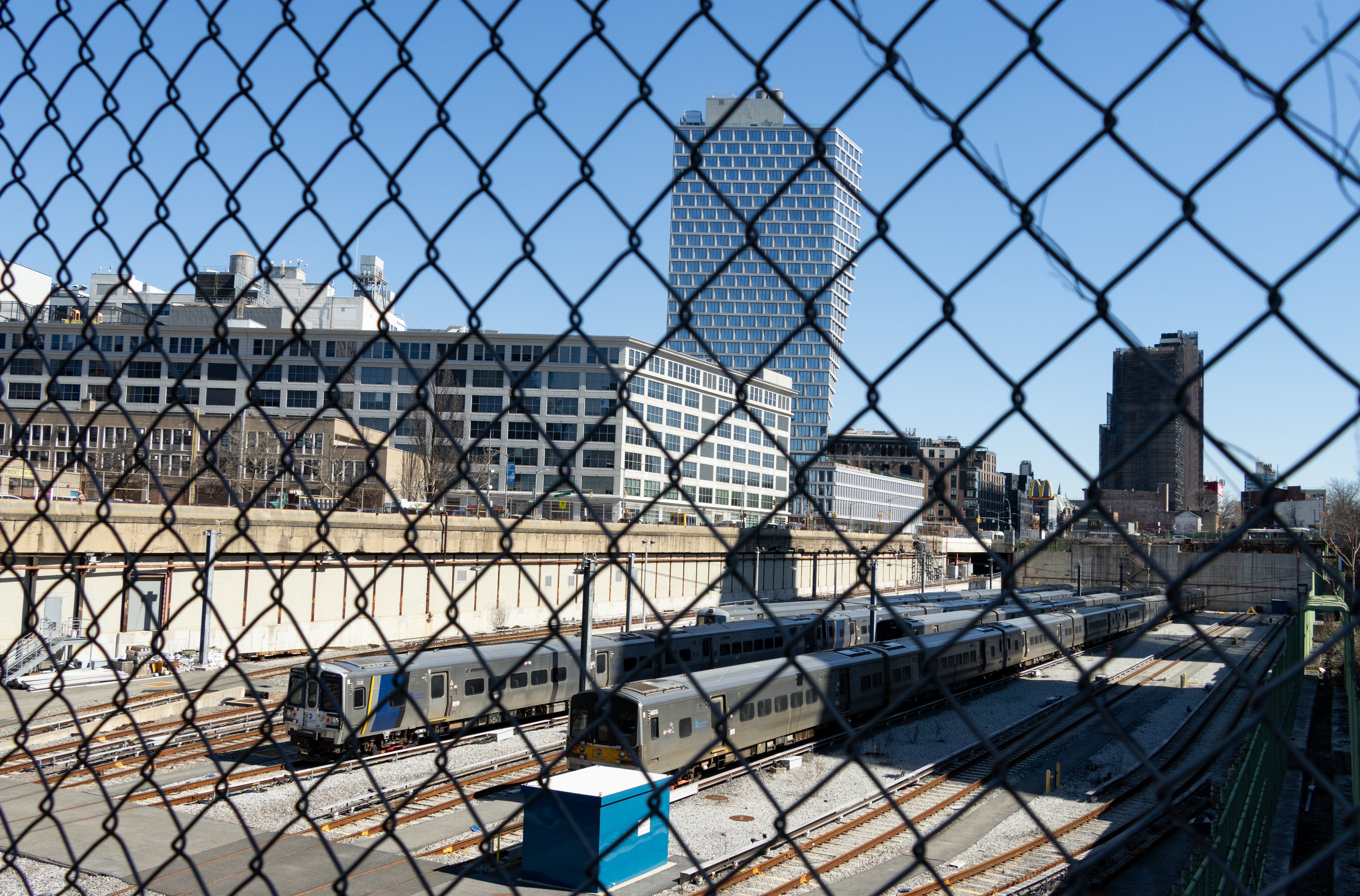 brooklyn - view through chain link fence to railyard with view of bildings in fort greene and clinton hill beyond