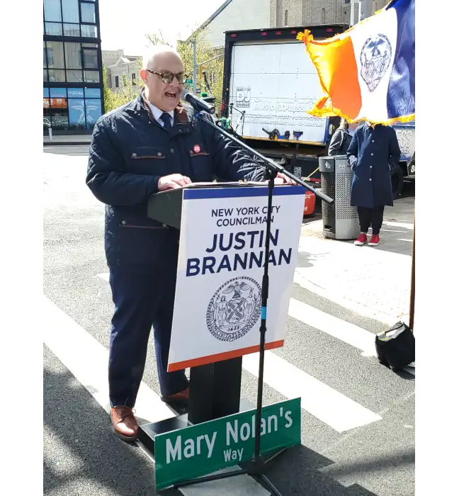 Council Member Justin Brannan speaks at the street renaming ceremony honoring Mary Nolan at 95th Street and Fourth Avenue in Bay Ridge on April 27, 2025.