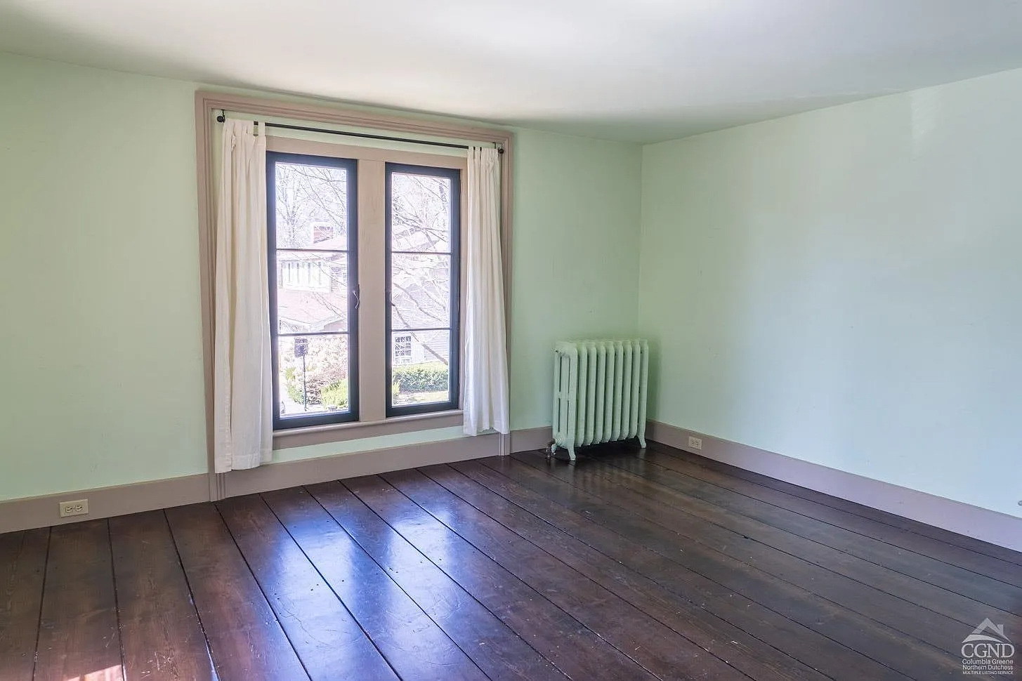bedroom with green walls, greige painted trim
