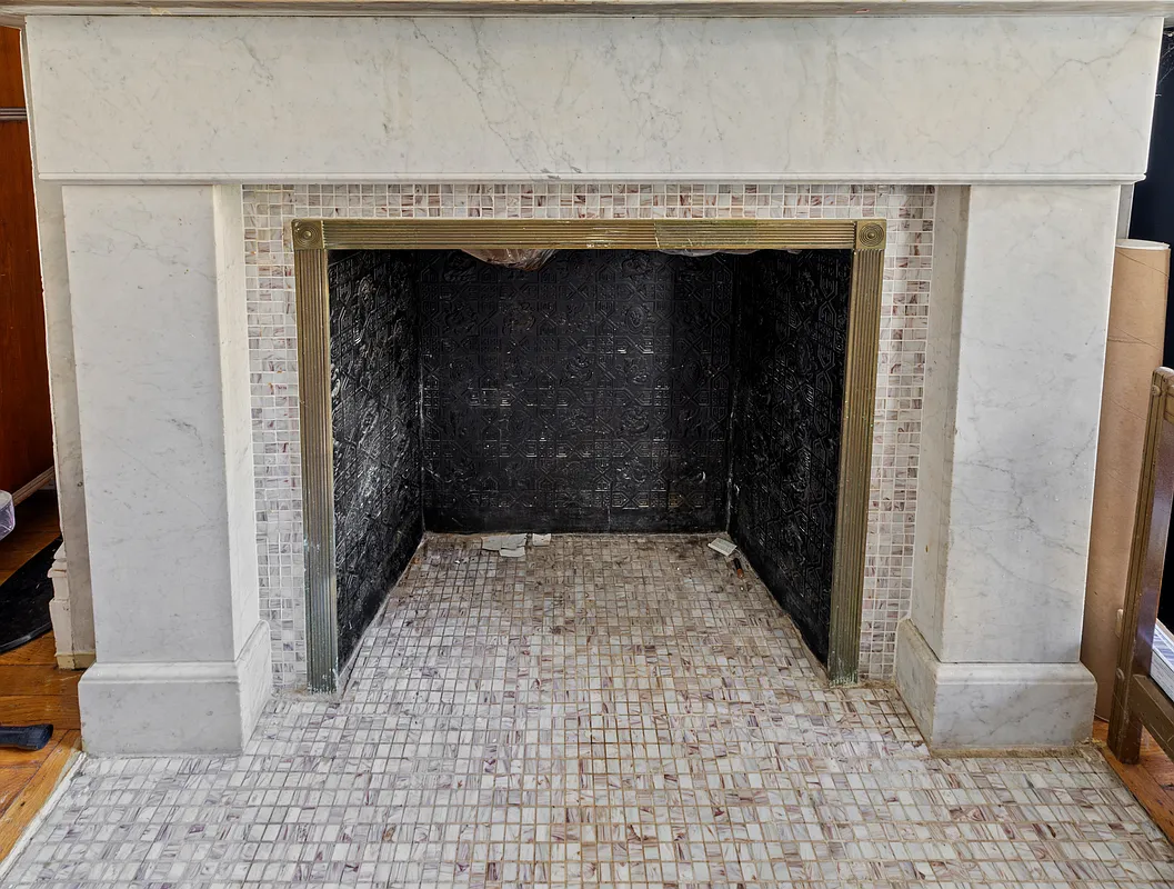 detail of a greek revival mantel with modern tile surround and hearth