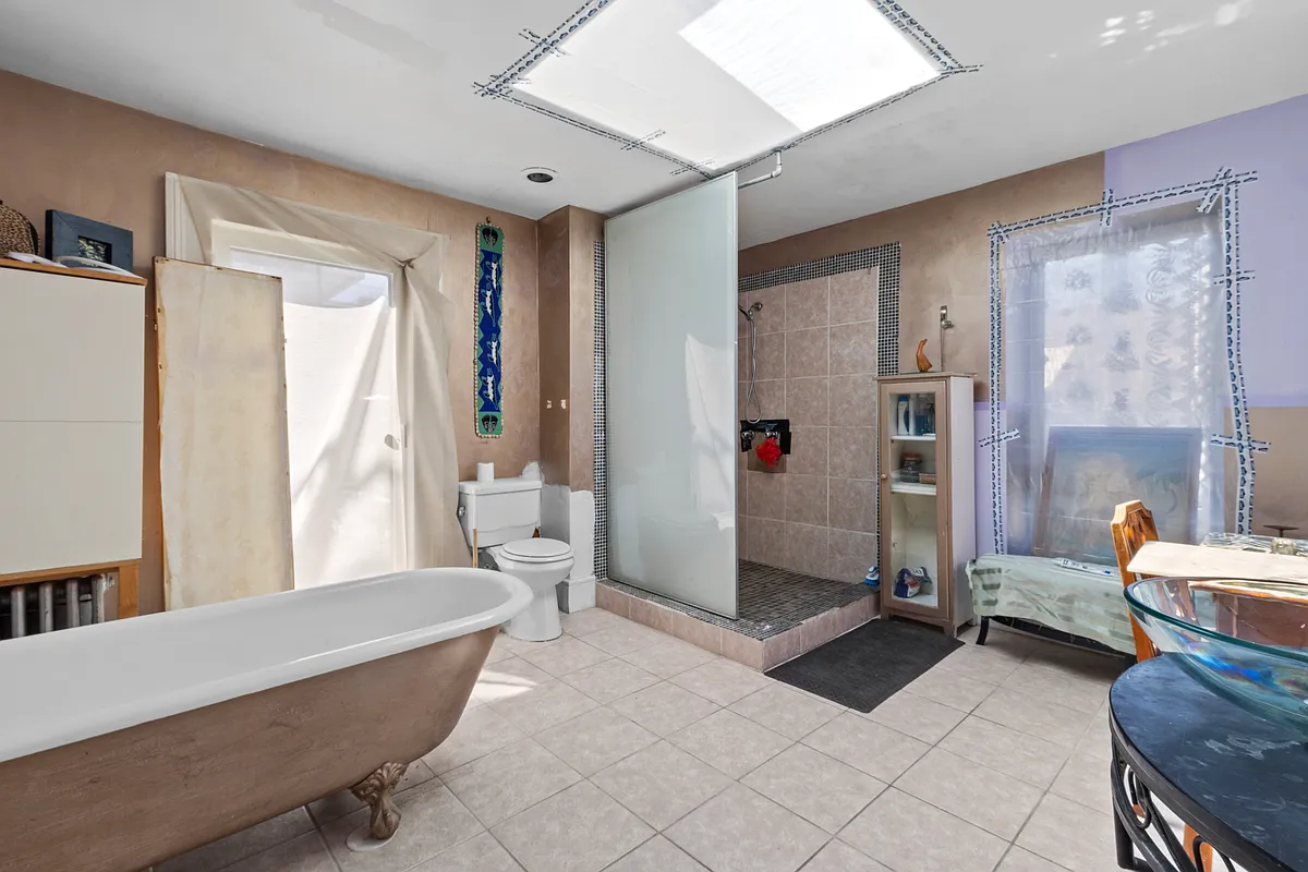 upstairs bathroom with work in progress, skylight, claw foot tub