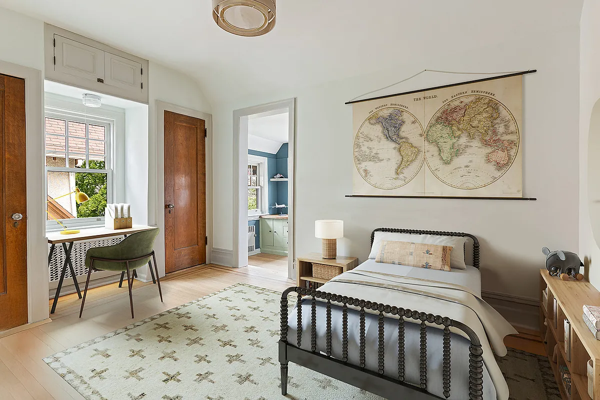 bedroom with pale floors and cream walls
