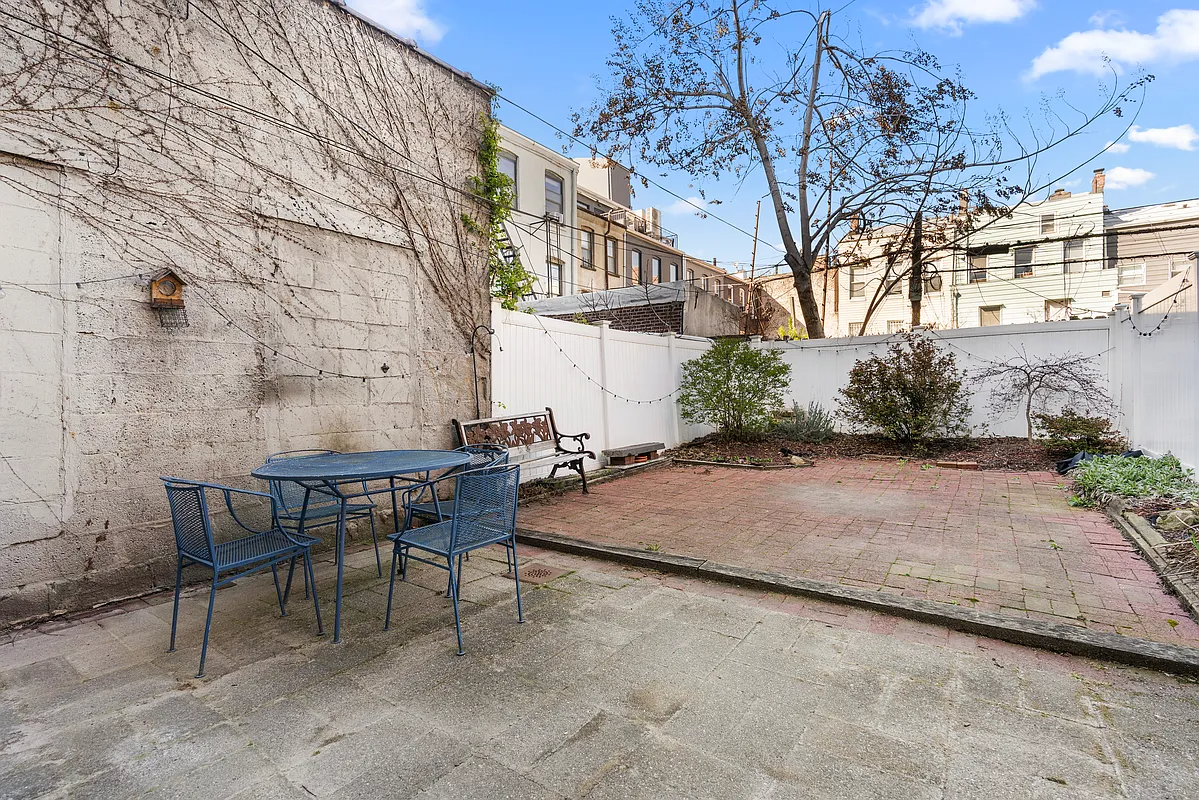 paved rear yard with planting bed at rear