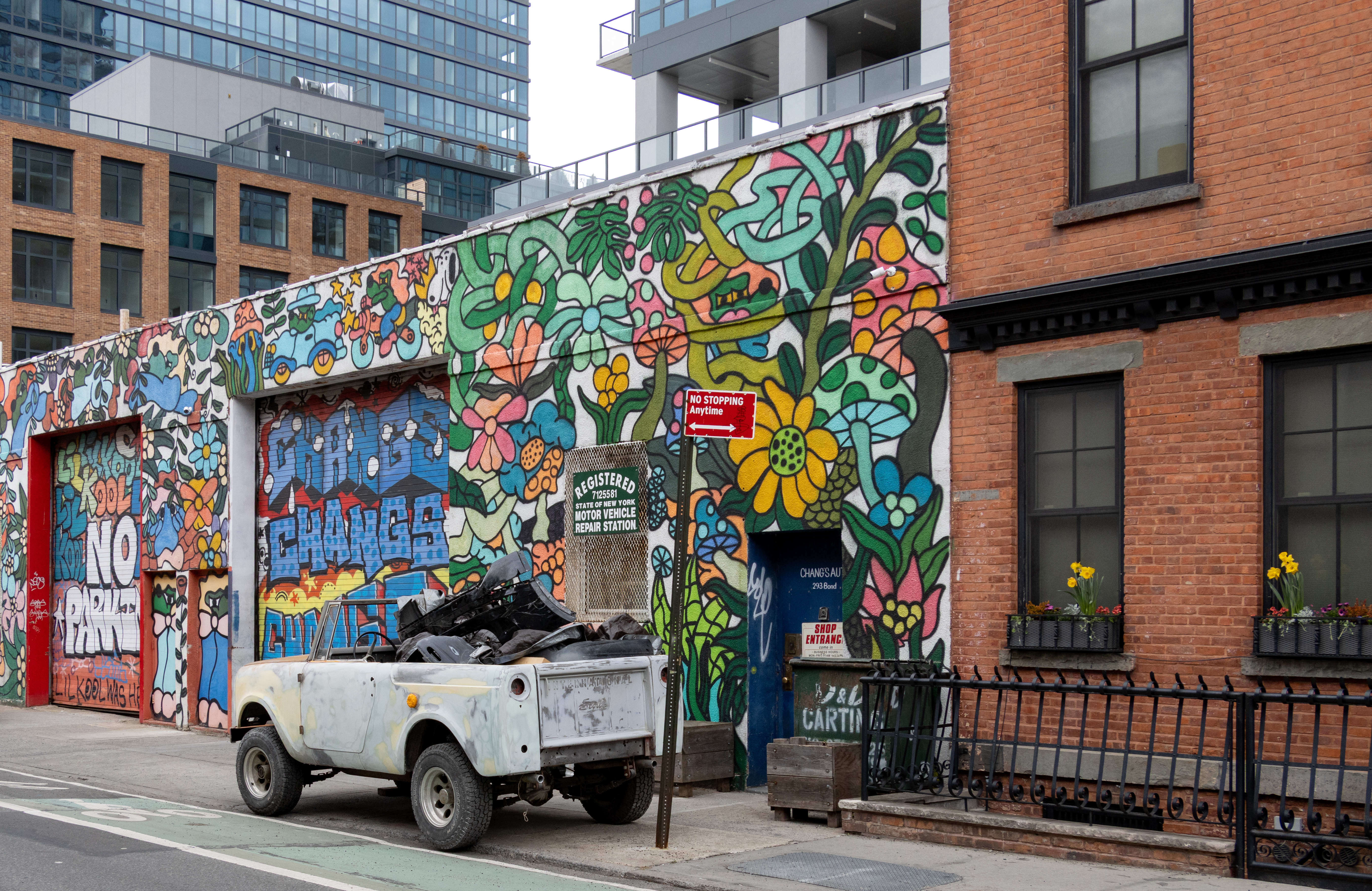 gowanus - daffodils in window boxes and a mural covered building at 293 bond street