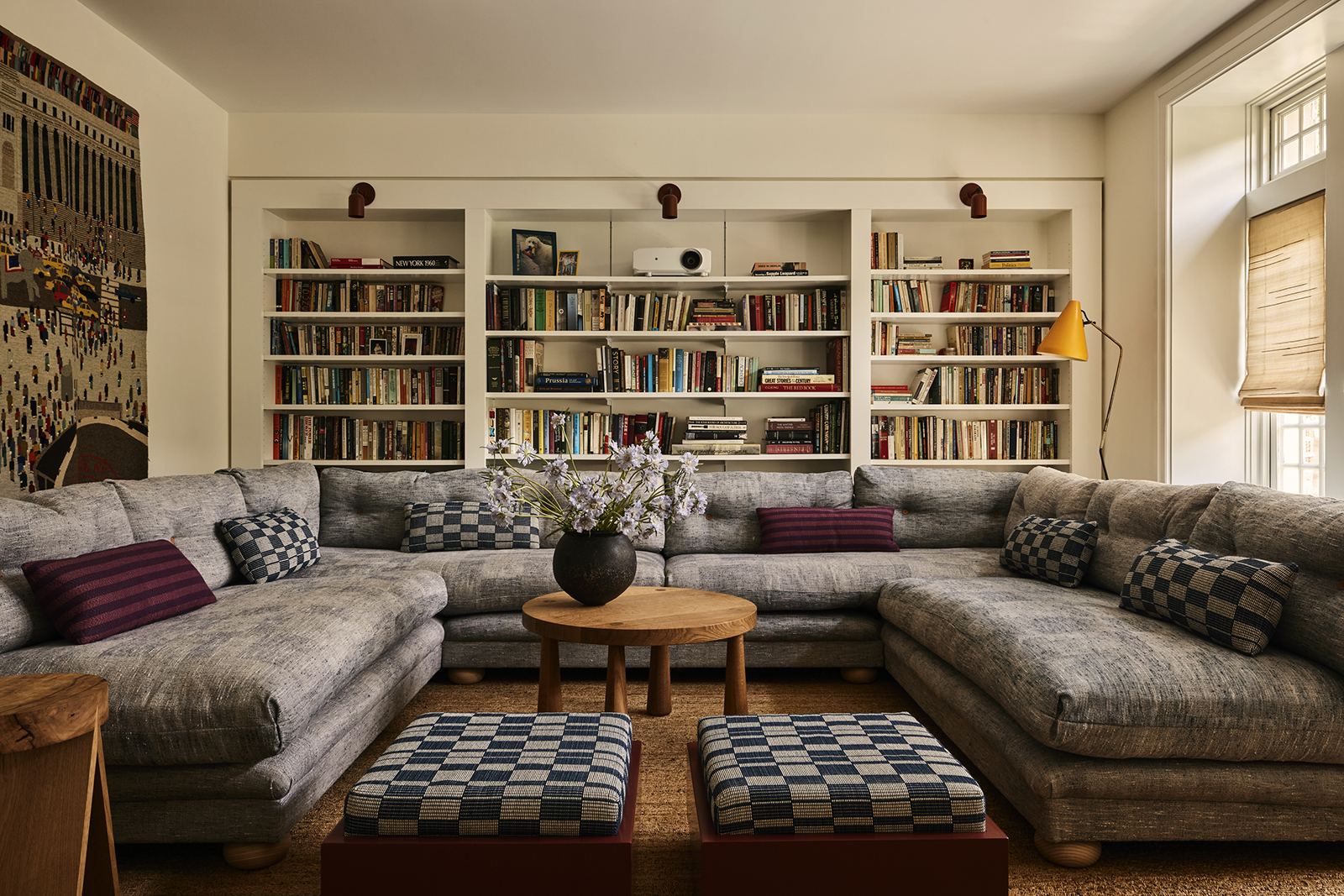 SITTING ROOM WITH SECTIONAL AND WALL OF BOOKS