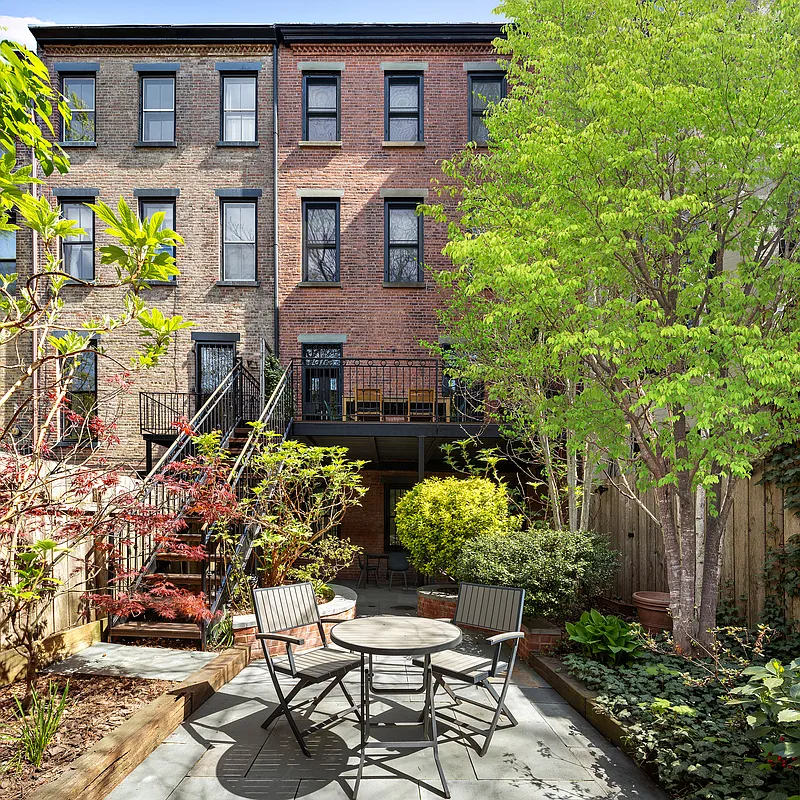 rear yard with paved patio, planting beds