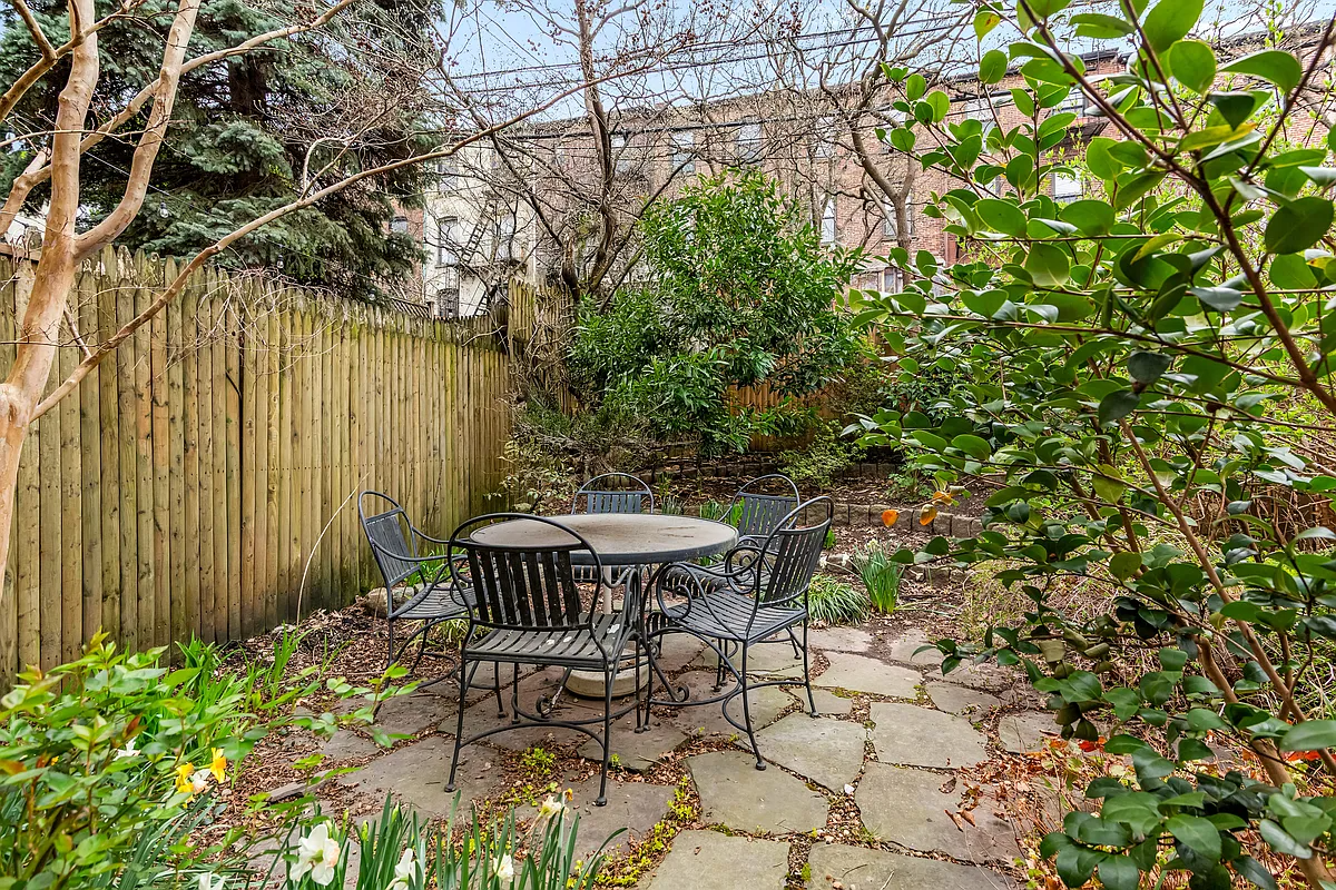 paved rear yard with planting beds