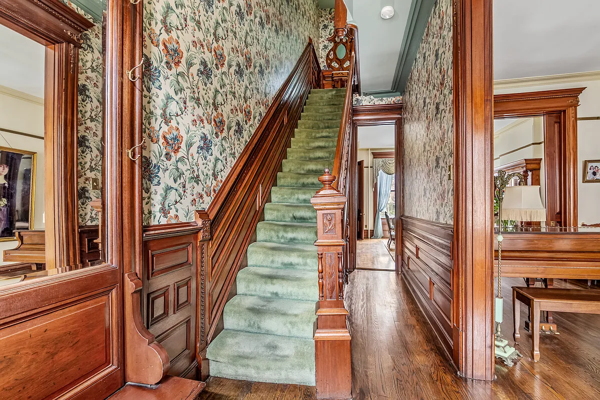 entry hall with wainscoting and wallpaper