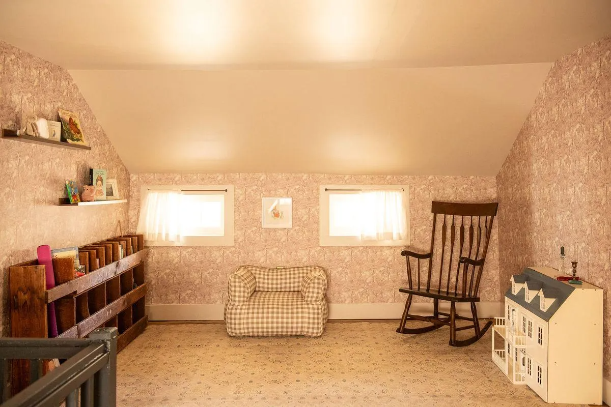 nursery with mauve wallpaper,