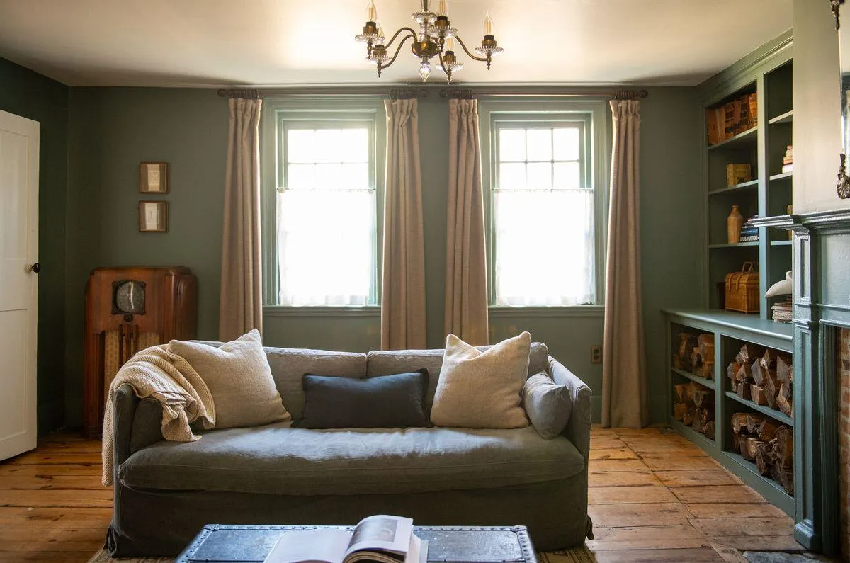 living room with built-in bookshelves, mantel