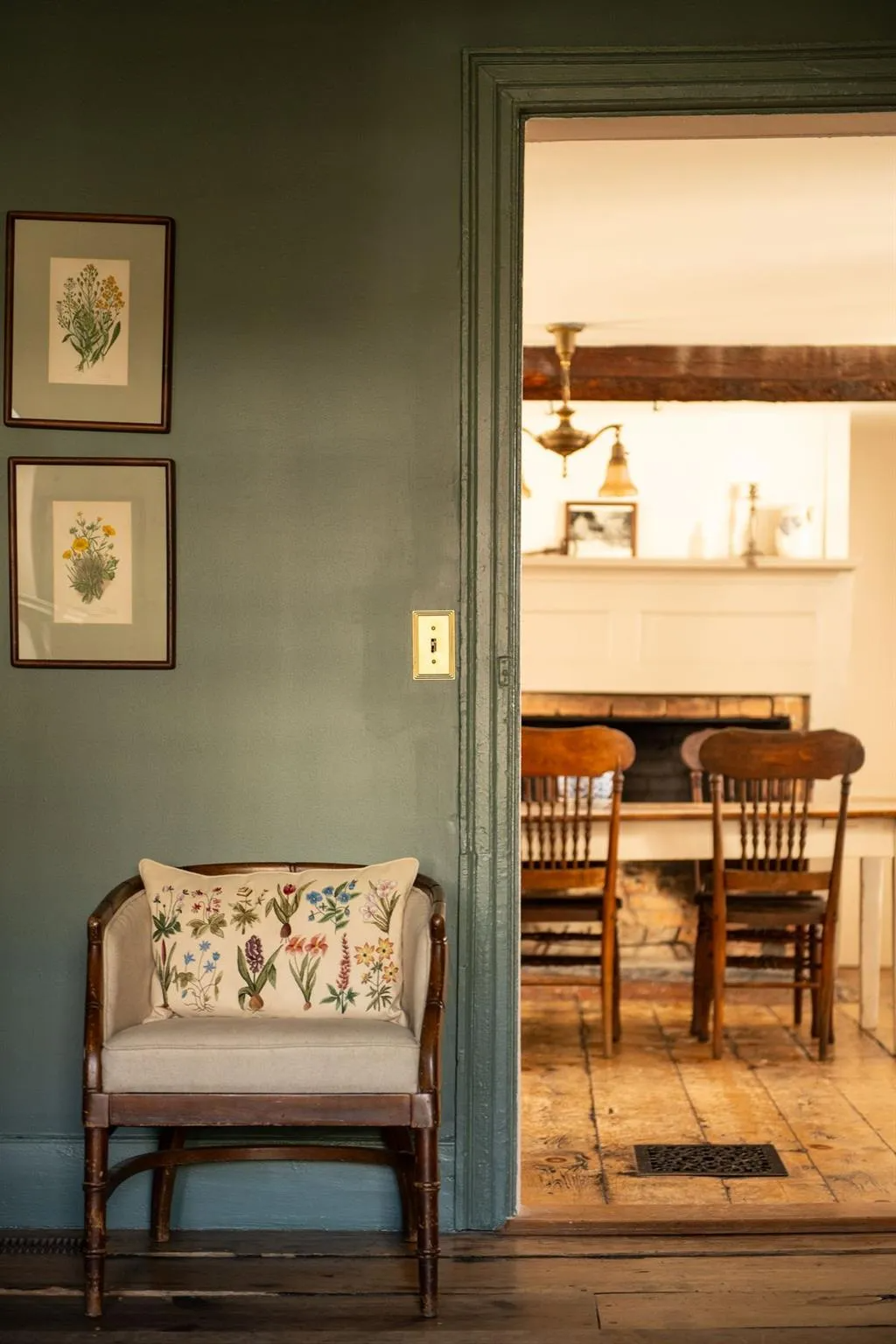 view from living room into dining room with view of wide planked floorboards