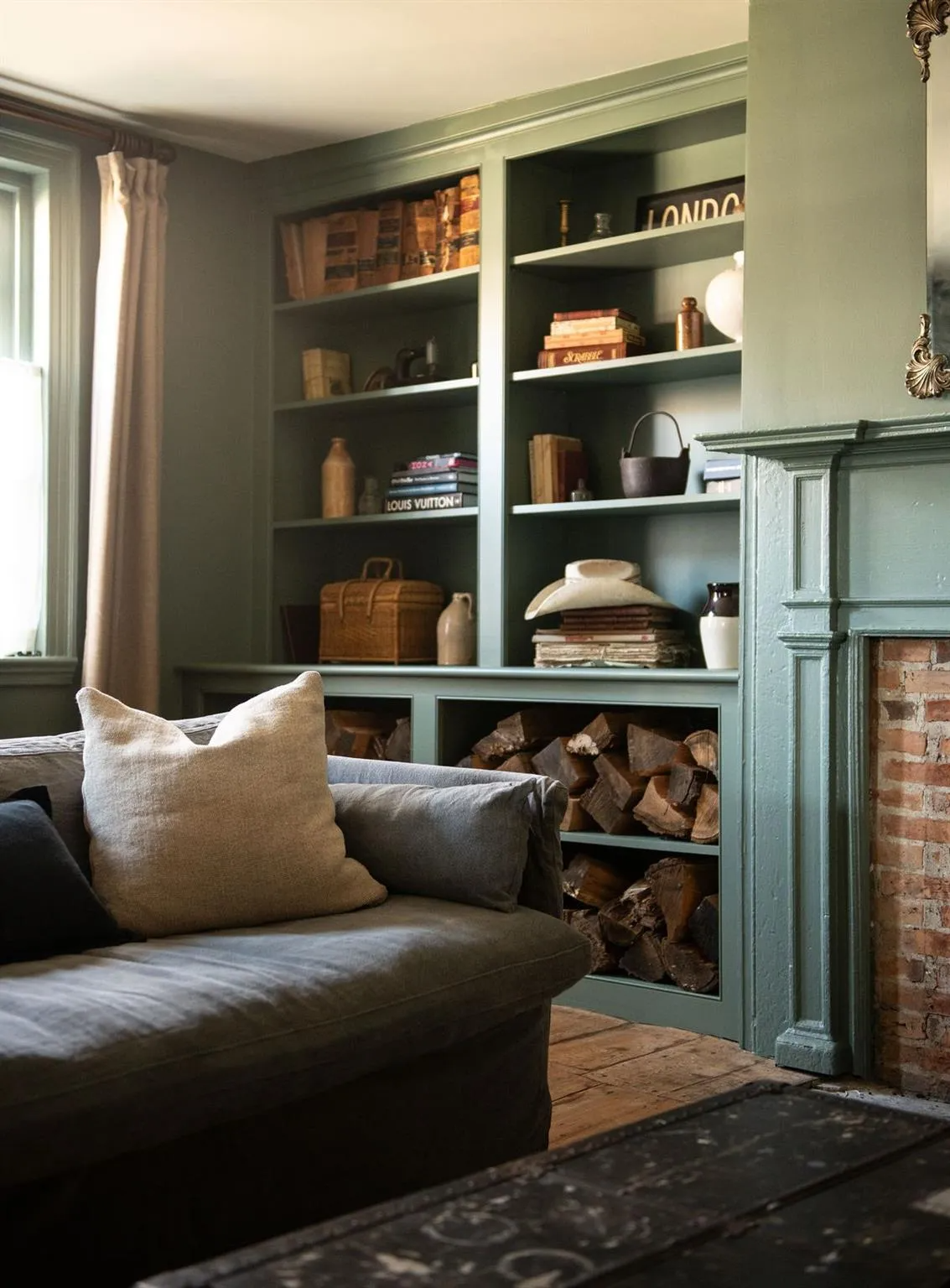 living room with built-in bookshelves, mantel