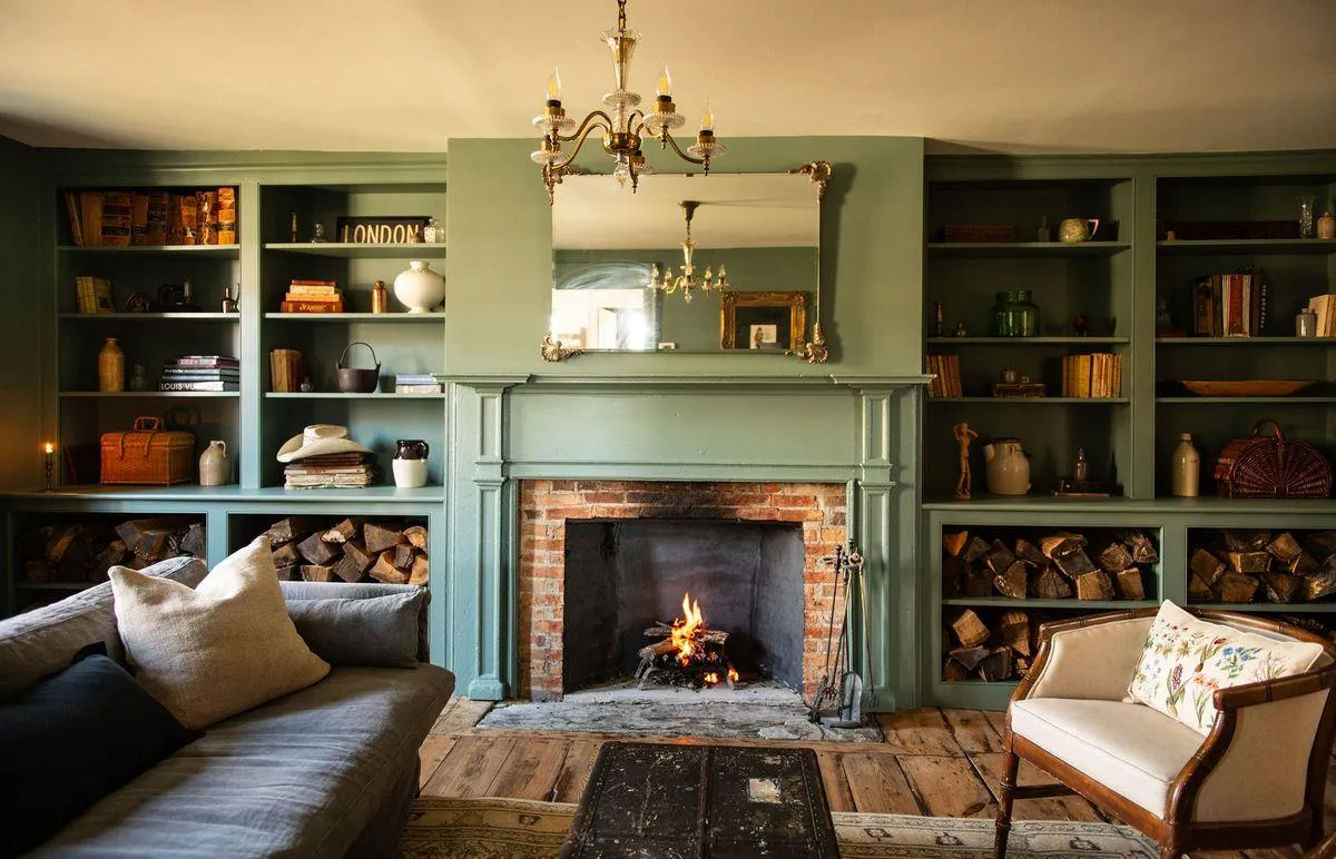 living room with built-in bookshelves, mantel