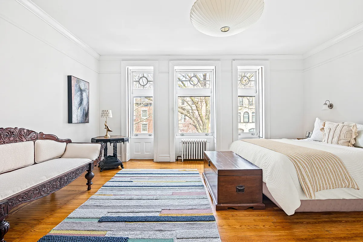 bedroom with wood floor, picture rails