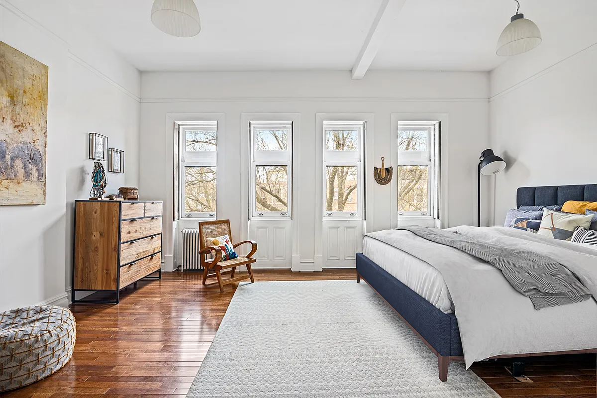 bedroom with white walls, picture rail, wood floor