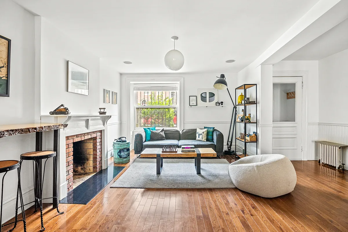 garden level dining room with wood floor, white painted mantel