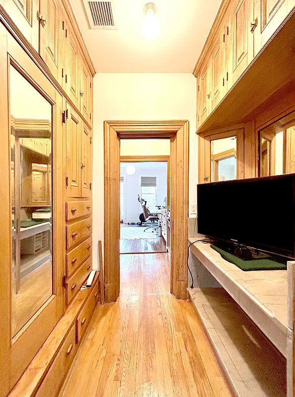 passthrough with built-in cabinets and a marble sink