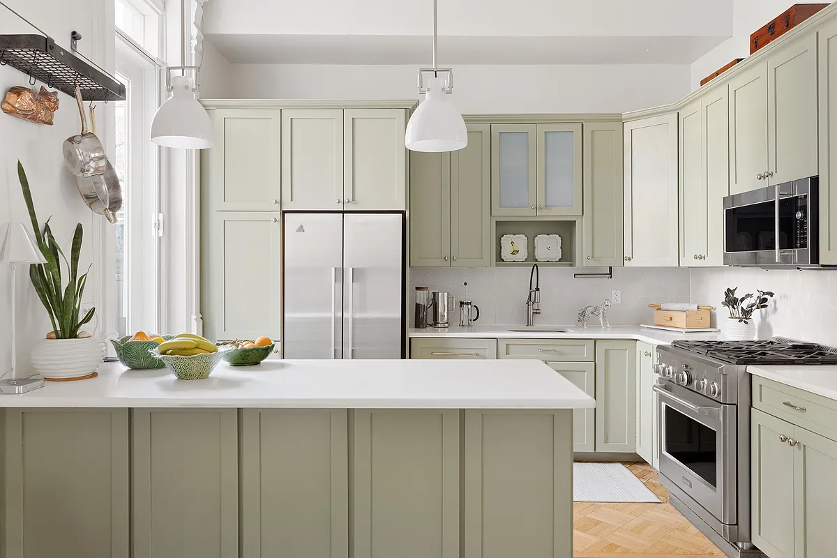 kitchen with sage green cabinets, white counters