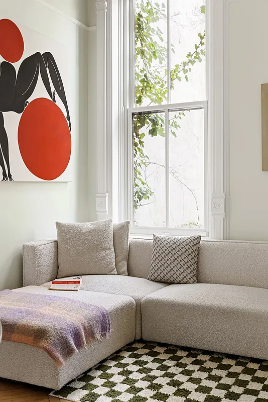 lliving room with pale walls, picture rail, tall window