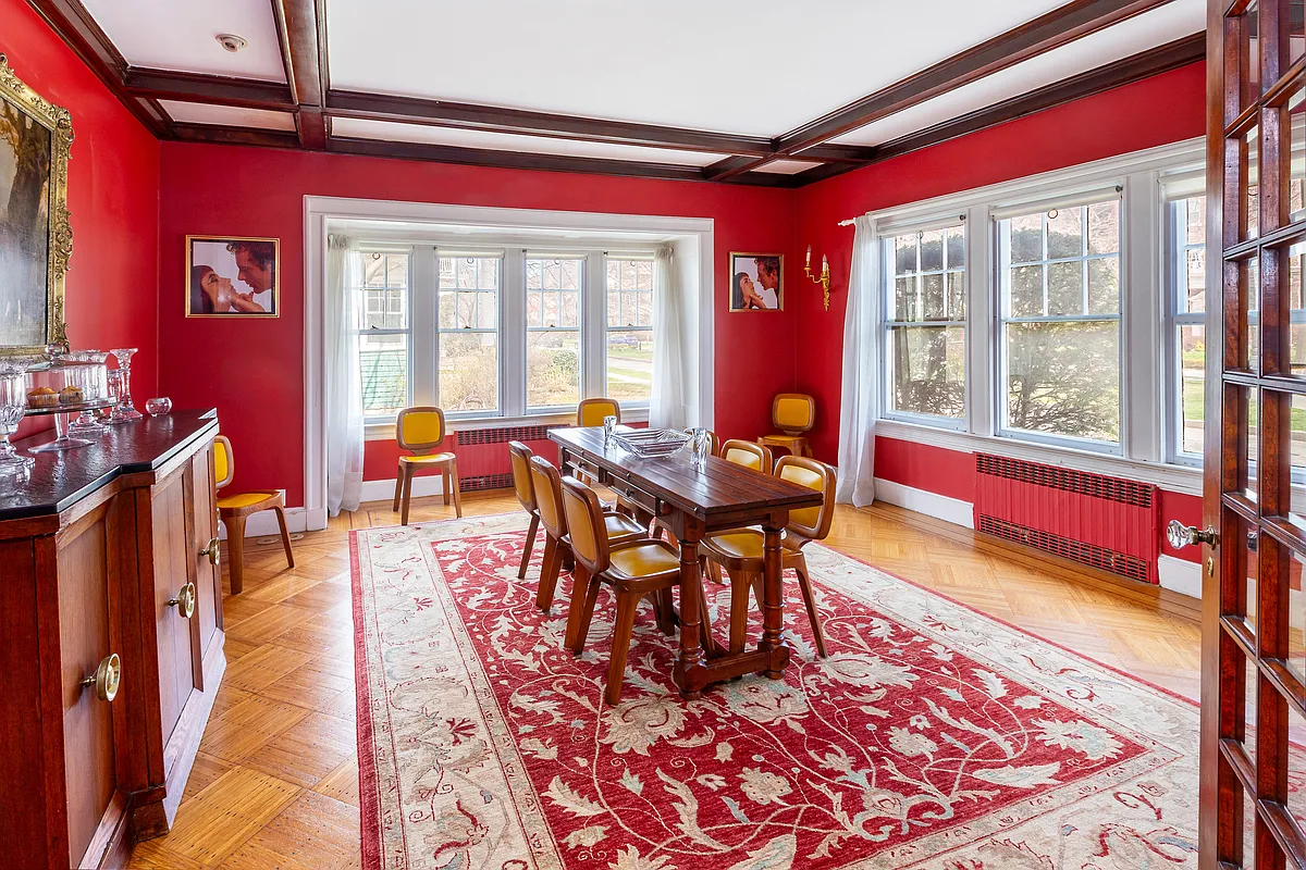 dining room with beamed ceiling, wood floor, two exposures