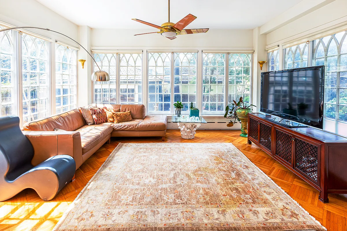 sun room with gothic revival windows, wood floor