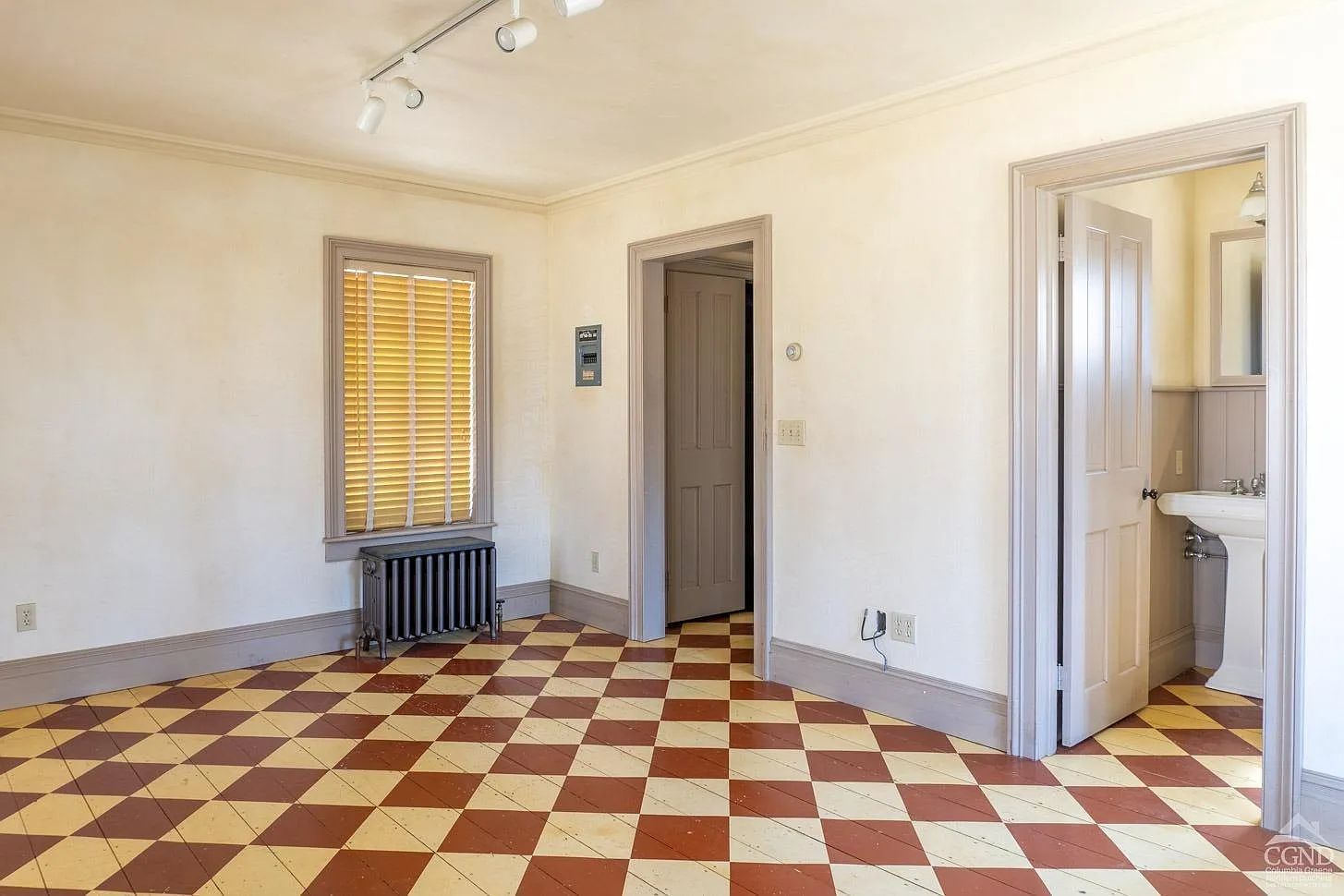 bedroom in addition with checkerboard painted wood floor with en suite bath