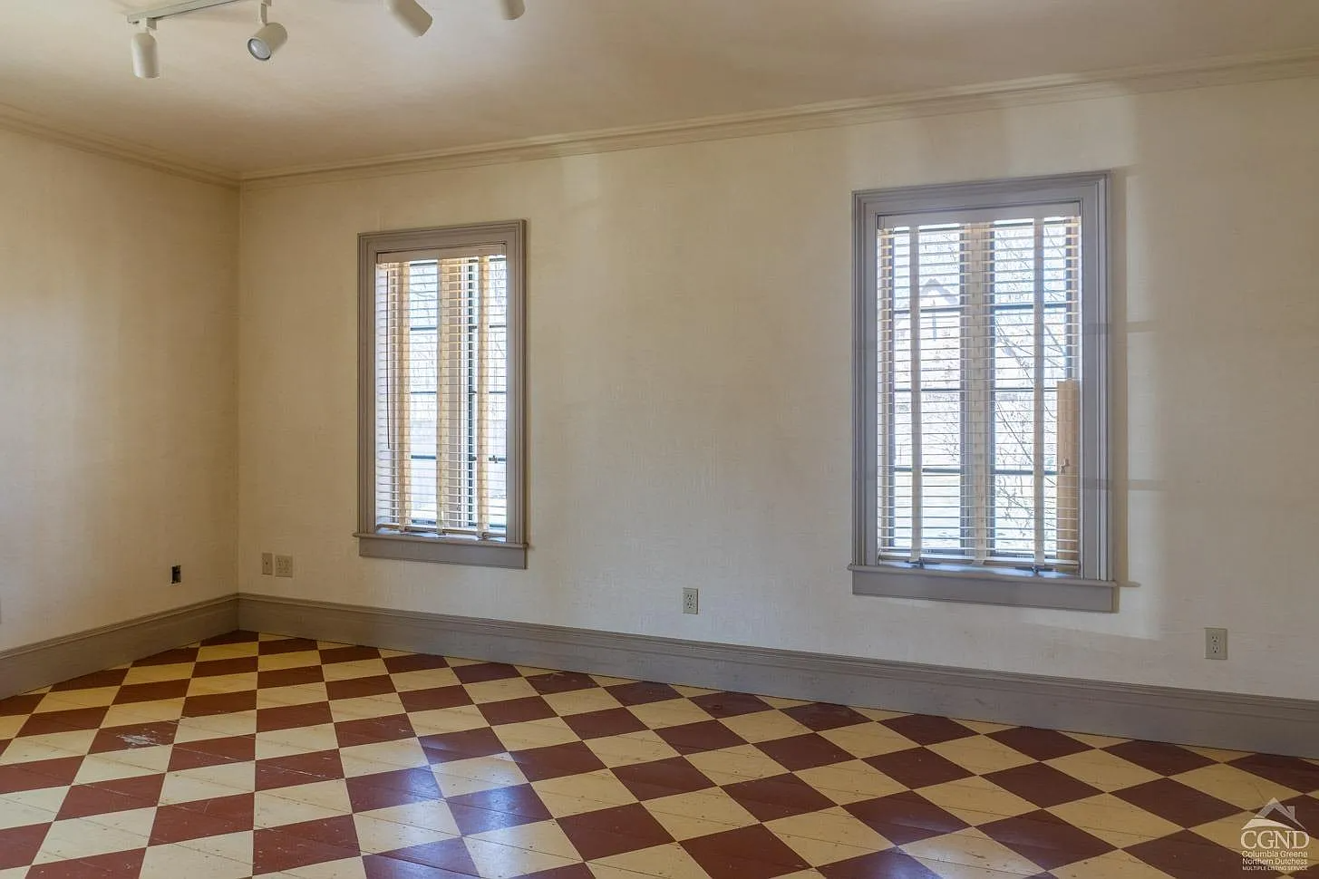 bedroom in addition with checkerboard painted wood floor