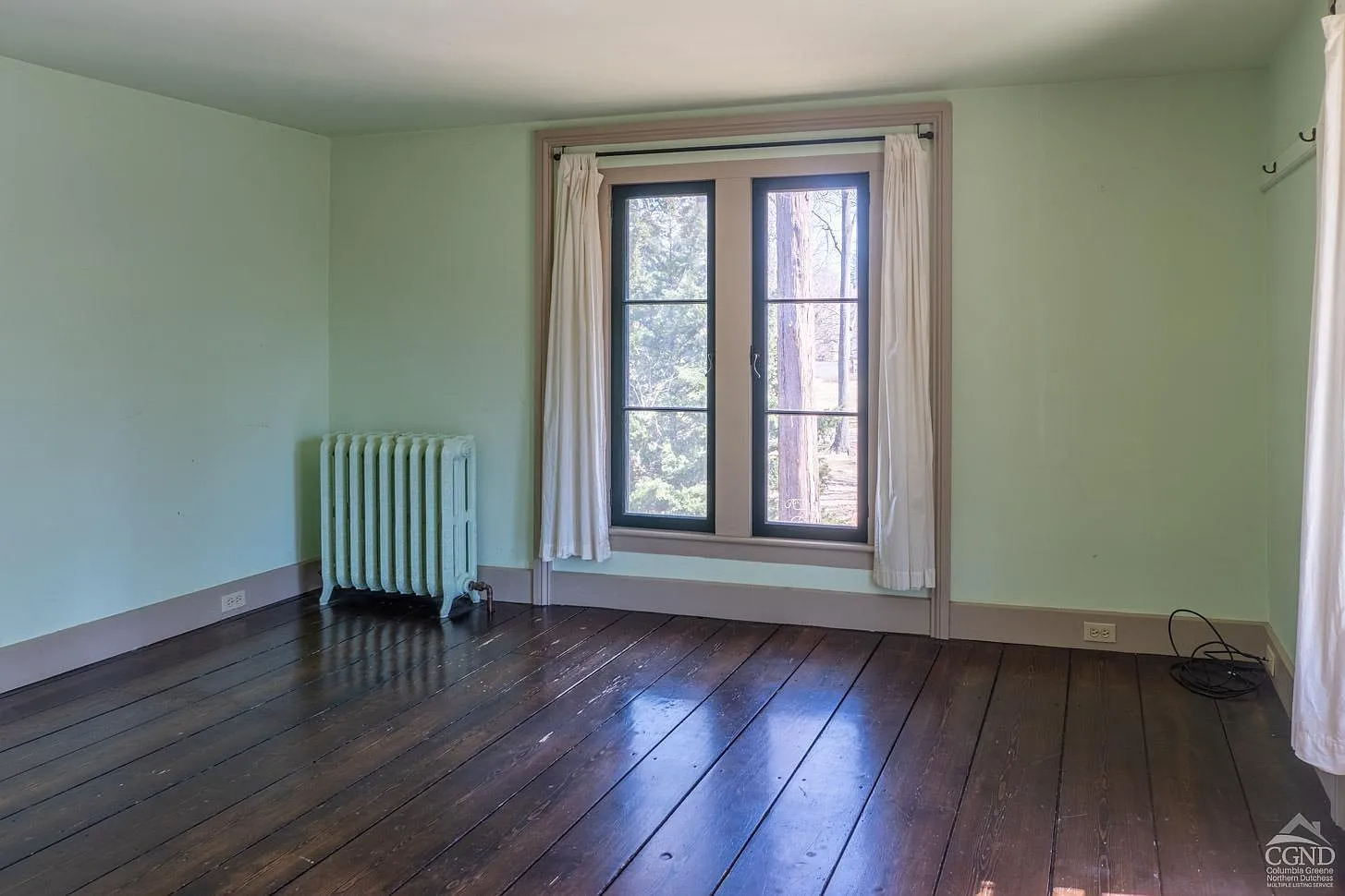 bedroom with green walls, greige painted trim