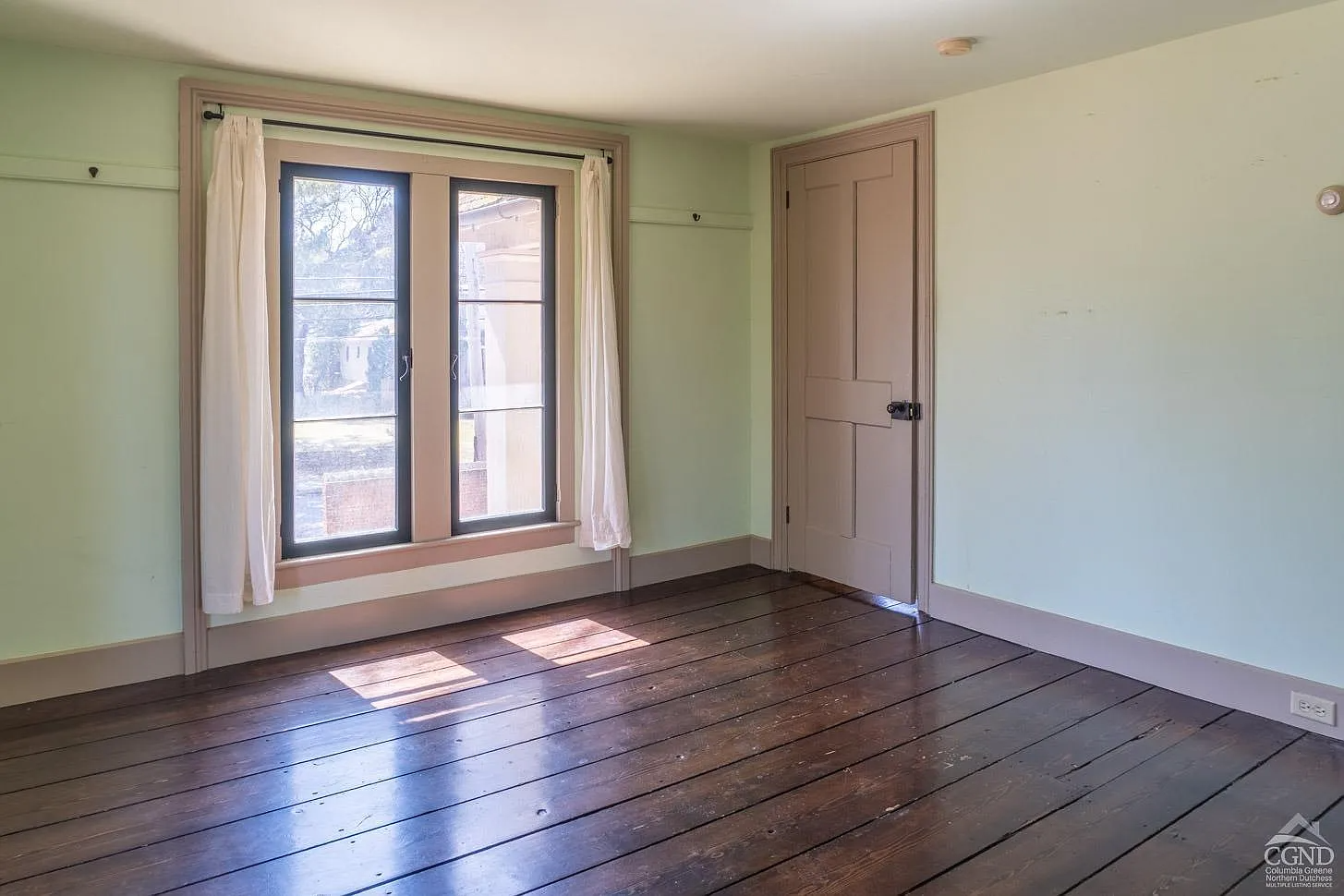 bedroom with green walls, greige painted trim
