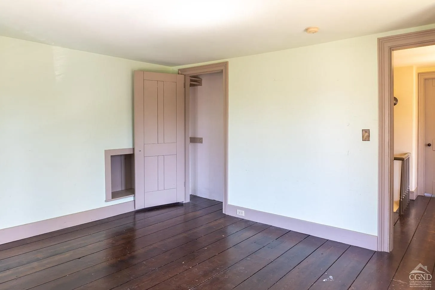bedroom with a wood floor and a very shallow closet
