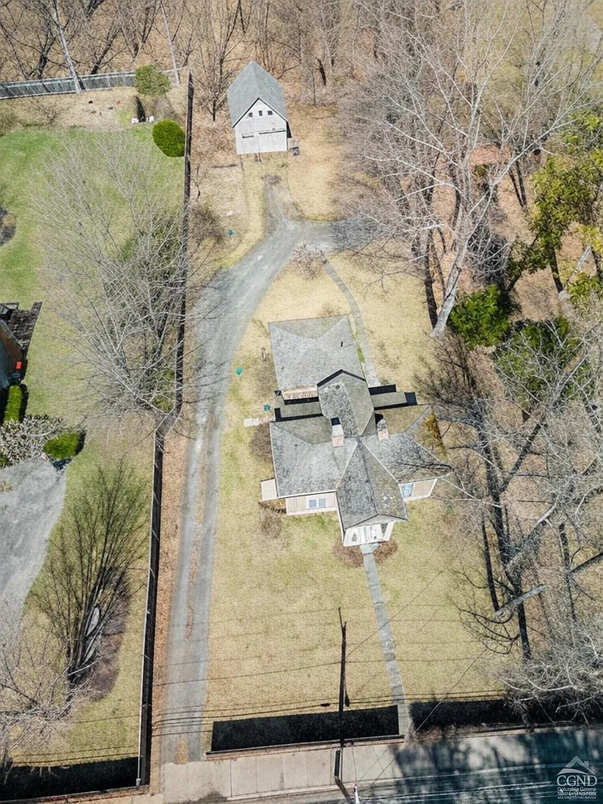 aerial view showing the house with the barn at the rear of the lot