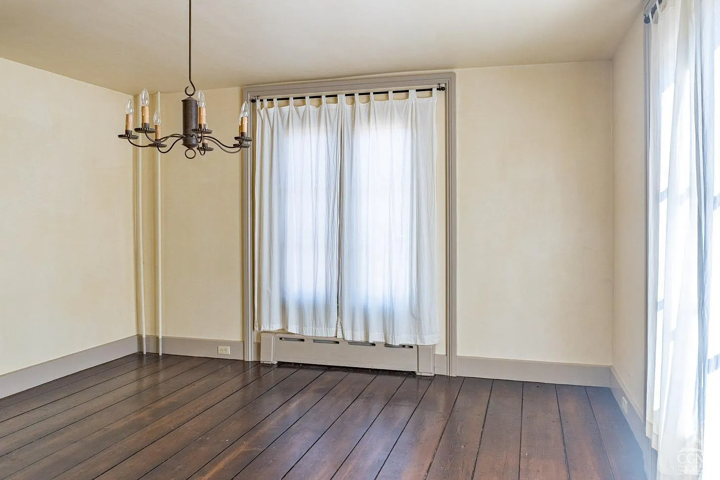 parlor with wood floors, painted trim