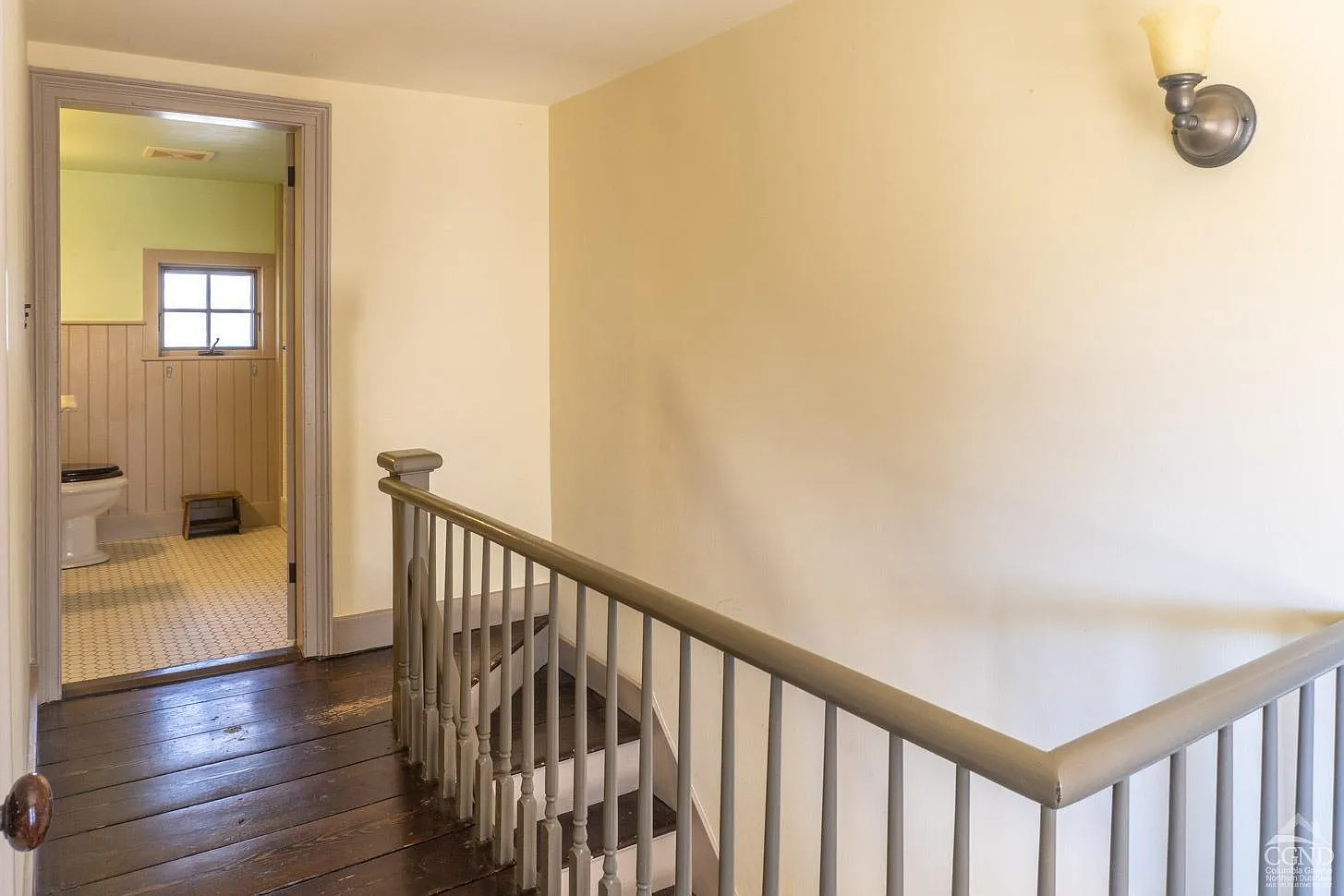 upstairs stair landing with view into a bathroom
