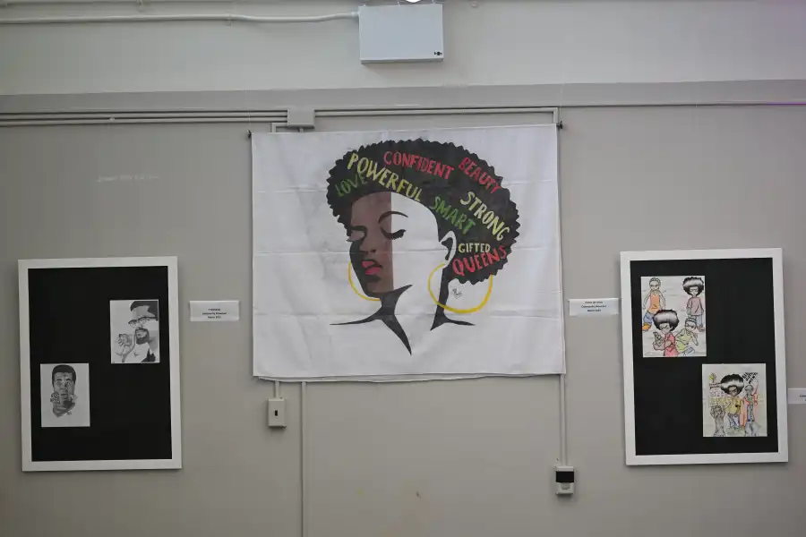 Some of the original artwork by Rikers Island detainees hanging in a Bed-Stuy, themed around the meaning of community.